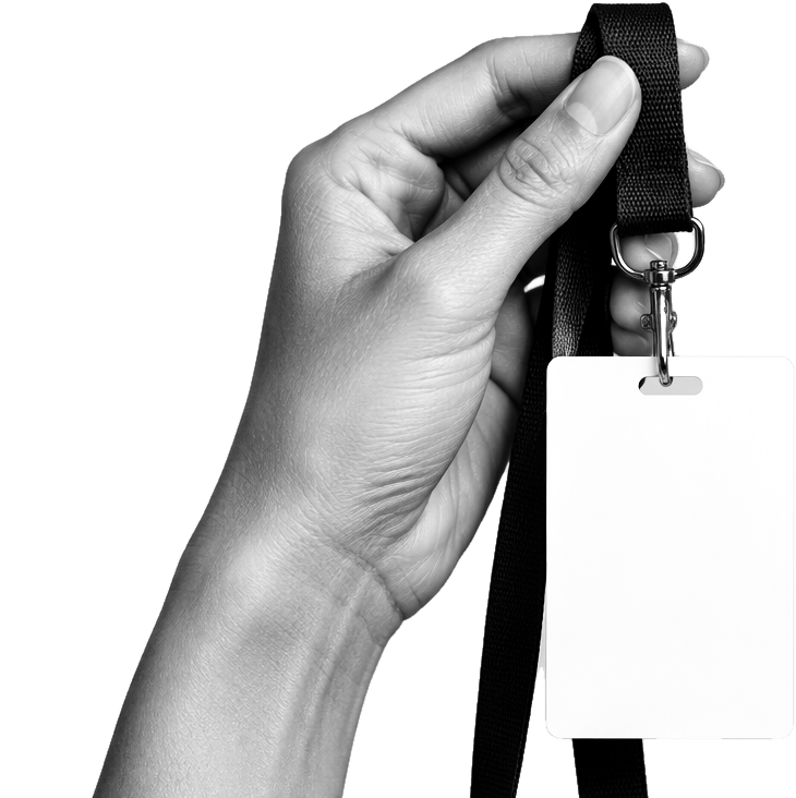 A hand holding up a blank event badge on a lanyard